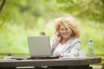 Business Lady Using Laptop In Park Stock Photo