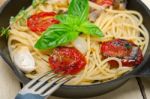 Spaghetti Pasta With Baked Cherry Tomatoes And Basil Stock Photo