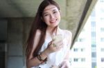 Portrait Of Thai Adult Beautiful Girl Using Her Smart Phone And Smile Stock Photo