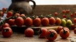 Cherry Tomatoes On Display On Wooden Chopping Board And Wooden Table Stock Photo