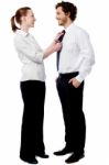 Pretty Woman Adjusting Her Husband's Tie Stock Photo