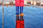 Legs Of Little Girl Standing In A Pool Of Autumn Stock Photo