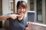 Portrait Of Thai Adult Beautiful Girl Using Her Tablet Stock Photo