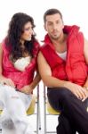 Young Couple Sitting On Chair Stock Photo