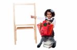 Young Cute Kid Sitting On A Pile Of Books Stock Photo