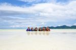 Happy Family Lying Together On The Beach, Thailand Stock Photo