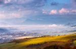 Foggy Sunny Morning In Mountain. Misty Hills. Town In Valley Stock Photo