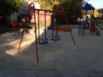 Children Playground, Swing Near The House  Stock Photo