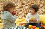 Children Play In The Park And Eating Apple Stock Photo