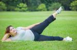 Fat Woman Lying By Exercise Leg Upwards Stock Photo