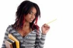 School Girl Posing With Pencil And Books Stock Photo