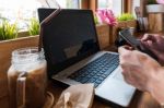 Coffee Cup  On A Table With Laptob And Graph Finance Diagram In Stock Photo