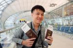 Man With Thailand Passports In Hands At Airport Stock Photo