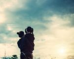 Mother And Daughter On Sunset Watching On Sky Stock Photo