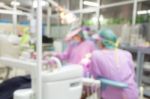 Dentist And Dental Assistants In Hospital ( Blurry Dental Background ) In Thailand Stock Photo