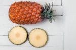 Fresh Azores Pineapple Fruit Isolated On A White Wooden Background Stock Photo