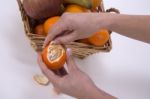 Woman Hands Peeling A Mandarin Stock Photo