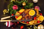 Christmas Baked Duck Served With Potatoes, Orange And Tomatoes Stock Photo