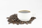 White Cup Of Coffee On Beans Stock Photo