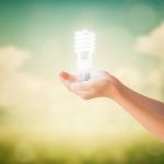 Hands Of Little Girl Holding Light Bulb Stock Photo