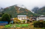 Farm And Houses Near Mountain With Autumn Color Stock Photo