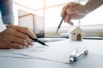 Architects Engineer Discussing At The Table With Blueprint - Clo Stock Photo