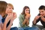 Teenagers Eating Pizza Stock Photo