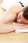 Man Receiving Stone Therapy Massage Stock Photo