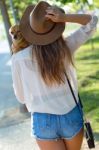 Beautiful Young Woman Walking With Her Dog In The Park Stock Photo