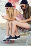 Beautiful Young Women Using Mobile Phone In The Street Stock Photo