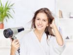 Woman Drying Hair At Home Stock Photo