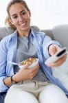 Beautiful Young Woman Eating Cereals At Home Stock Photo