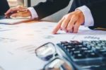 Businessman's Hands With Calculator At The Office And Financial Stock Photo