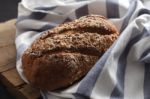 Dark Multigrain Bread Whole Grain Fresh Baked On Rustic Closeup Stock Photo