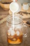 Milk Pouring For Fresh Iced Coffee Stock Photo