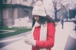 Beautiful Woman In Red Coat And Wool Cap And Gloves With Smartph Stock Photo