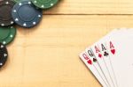 Cards And Poker Chips On Wooden Background Stock Photo