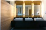 Commercial Bathroom With Three Sink And Mirror Stock Photo