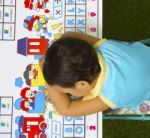 Child Sleeping On Educational Desk Stock Photo