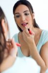 Beautiful Young Woman Making Make-up Near Mirror Stock Photo