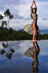 Pretty Brunette Model In Bikini Posing At The Pool Stock Photo