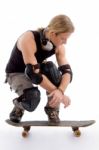 American Male Sitting On Skateboard Stock Photo