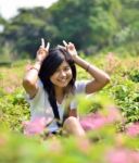 Portrait Of Sweet Young Woman Sitting Outdoors Stock Photo