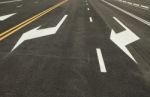 Traffic Sign On Black Asphalt Road Stock Photo