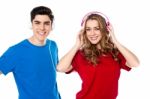 Adorable Young Couple Enjoying Music Stock Photo