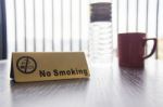 No Smoking Sign Displayed On Table Stock Photo