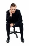 Young Male Sitting On Chair Stock Photo