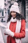 Beautiful Woman In Red Coat And Wool Cap And Gloves With Smartph Stock Photo