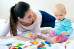 Baby Girl And Her Mother Playing At Home Stock Photo