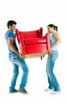 Couple Moving Armchair Stock Photo